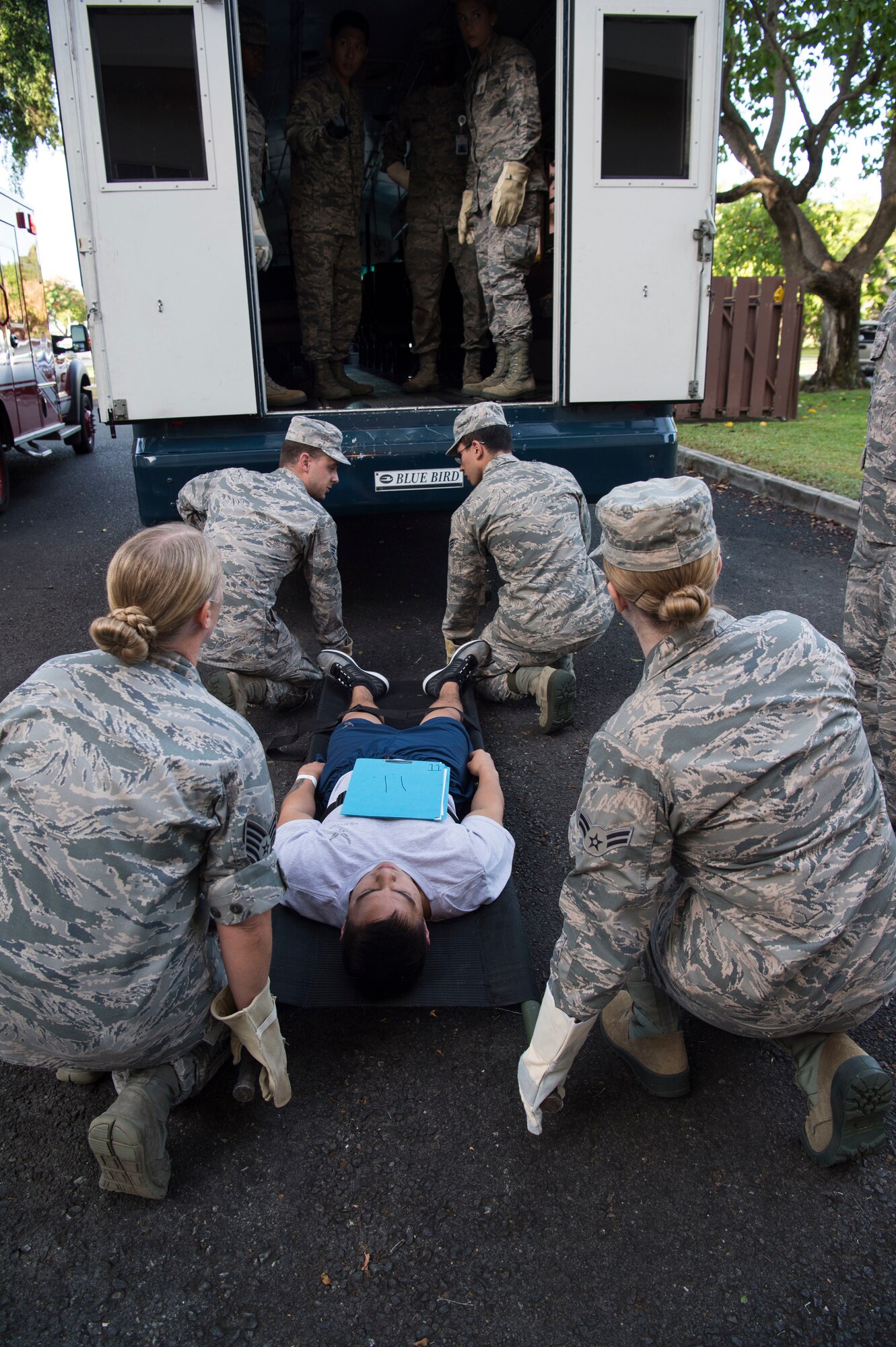 Airmen from the 15th Medical Group, work together to load mock casualties into a medical evacuation bus during a mass-casualty scenario for Rim of the Pacific exercise, Joint Base Pearl Harbor-Hickam, July 12. Twenty-five nations, 46 ships, five submarines, about 200 aircraft and 25,000 personnel are participating in RIMPAC from June 27 to Aug. 2 in and around the Hawaiian Islands and Southern California. The world’s largest international maritime exercise, RIMPAC provides a unique training opportunity while fostering and sustaining cooperative relationships among participants critical to ensuring the safety of sea lanes and security of the world’s oceans. RIMPAC 2018 is the 26th exercise in the series that began in 1971. (U.S. Air Force photo by Tech. Sgt. Heather Redman/Released)