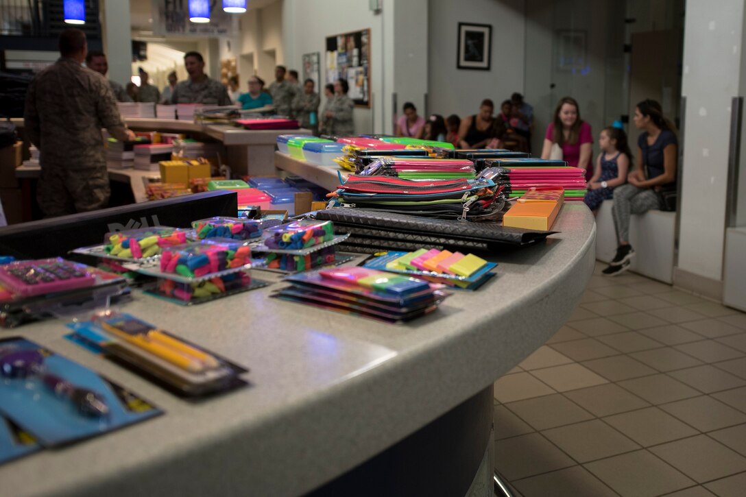 Airmen and families wait for the Back-To-School Brigade to kick off, July 25, 2018, at Moody Air Force Base, Ga. With the help of Operation Homefront and the local community, the event provided Moody Airmen, grades E-1 through E-6, with school supplies. (U.S. Air Force photo by Airman Taryn Butler)