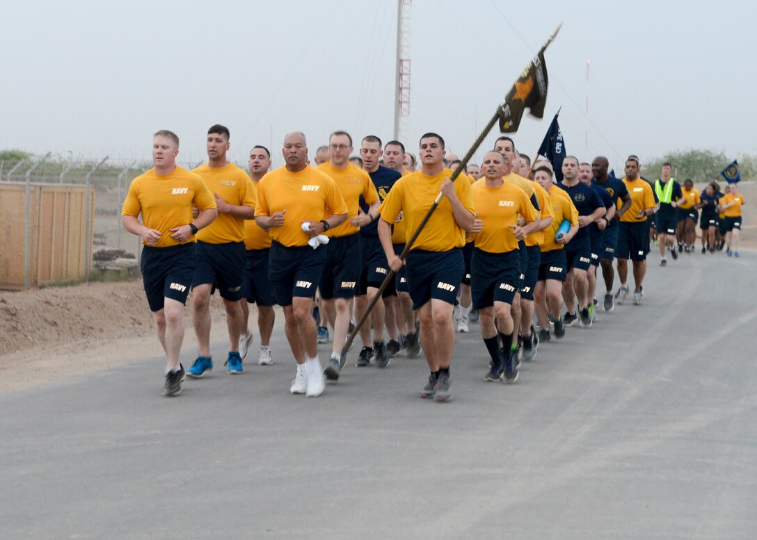 Sailors deployed to Camp Lemonnier, Djibouti, participate in an early morning group run as part of Chief Petty Officer 365 training.
