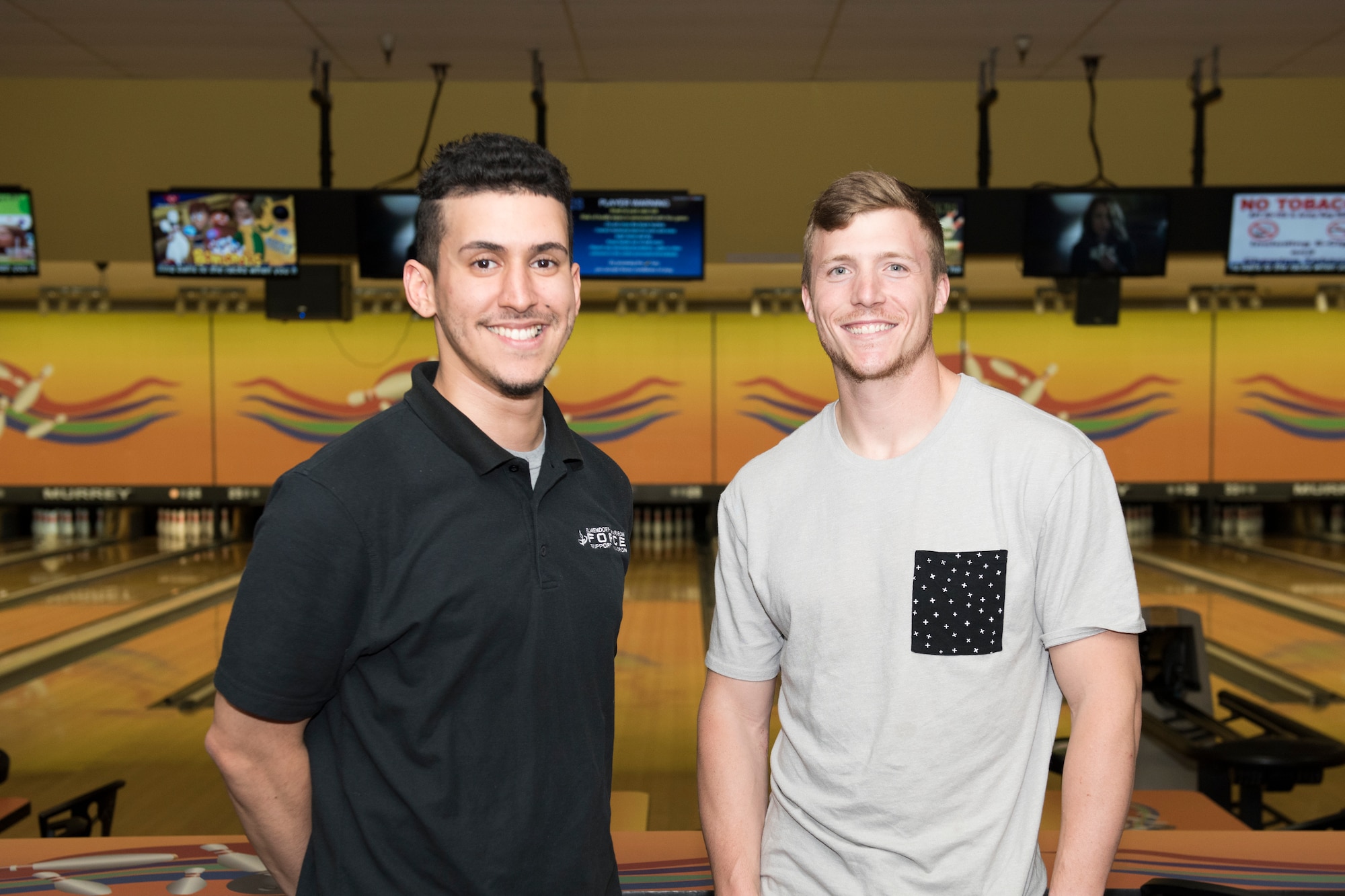 Staff Sgt. Chase McFeron, a 673d Civil Engineer Squadron explosive ordnance disposal craftsman, (right) and Luis Ruiz, Polar Bowl cashier, pose for a photo at the bowling alley at Joint Base Elmendorf-Richardson, Alaska, July 13, 2018. McFeron performed the Heimlich maneuver on Ruiz when he was choking on a piece of steak.