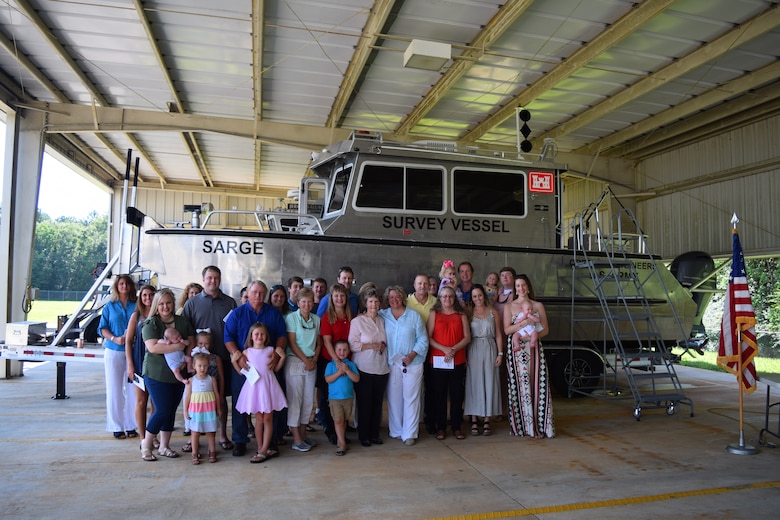 Members of former Irvington Site employee Stephen Sema’s family pose in front of the Sarge, a new survey vessel during a christening ceremony July 13, 2018, in Irvington, Ala.
