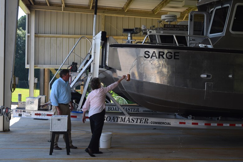 Ms. Doris Sema, wife of former Irvington Site employee Stephen Sema, christens the “Sarge”, a surveying vessel named after her husband during a christening ceremony July 13, 2018, in Irvington, Ala.