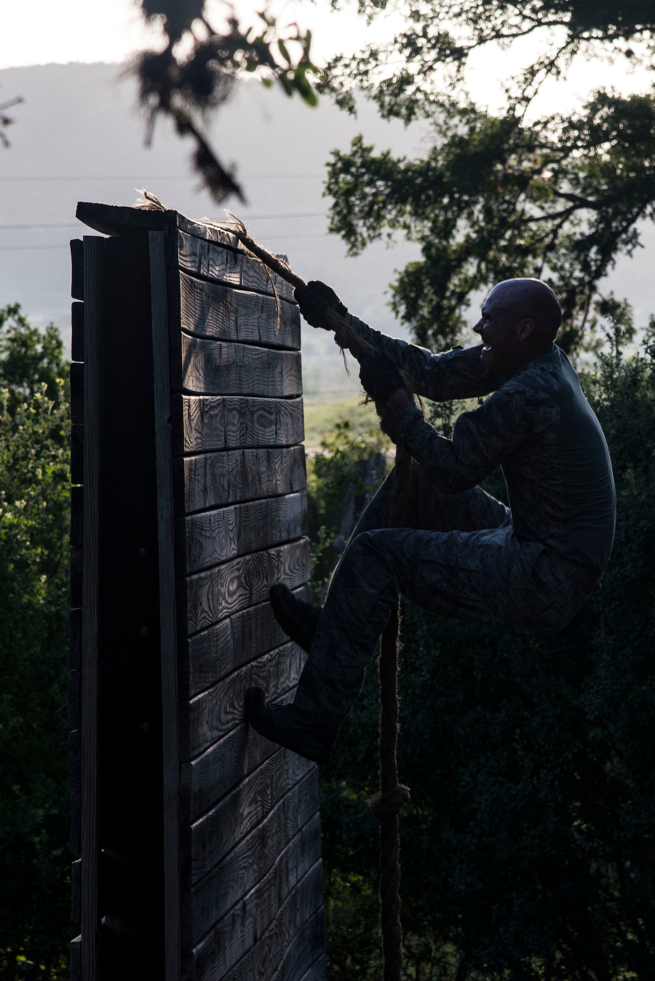 Capt. Nathan Spradley, 902nd Security Forces Squadron operations officer, climbs an obstacle July 23, 2018, at Joint Base San Antonio-Camp Bullis, Texas in preparation for the 2018 Defender Challenge. The competition will pit security forces teams against each other in realistic weapons, dismounted operations and relay challenge events. (U.S. Air Force photo by Senior Airman Stormy Archer)