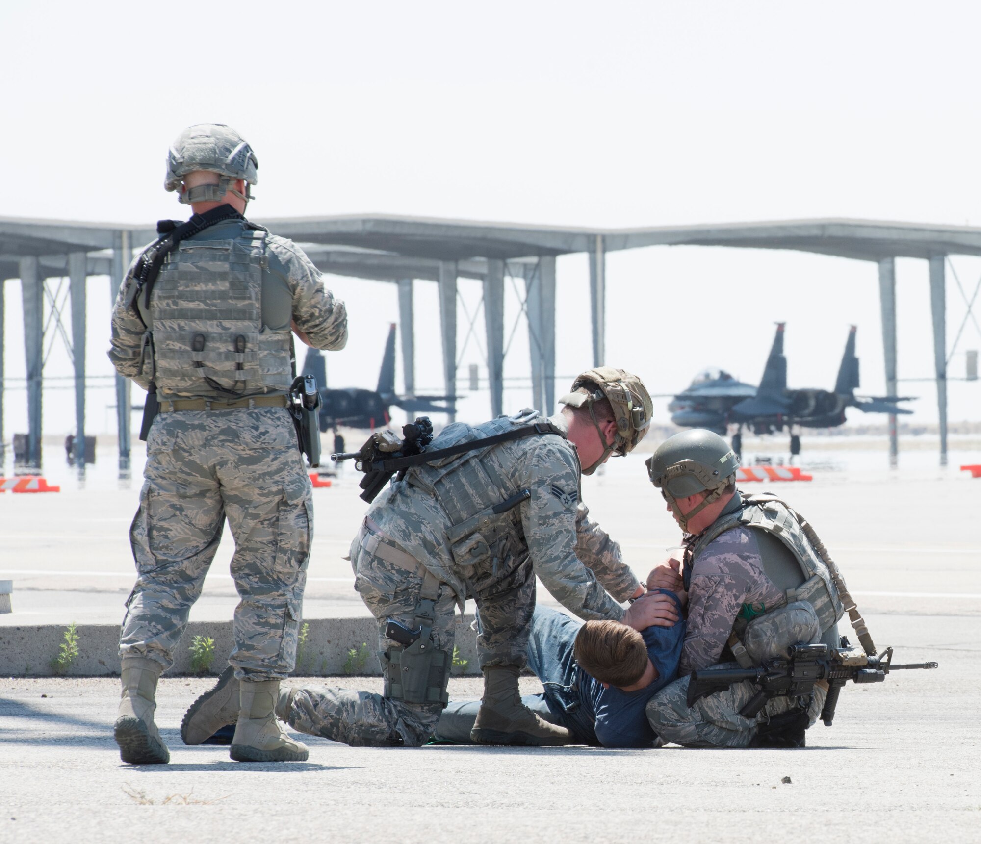 Members of the 366th Security Forces squadron arrest Airman 1st Class Trevor Gordnier, 366th Fighter Wing broadcast journalist, during a Force Protection Condition exercise, July 23, 2018, at Mountain Home Air Force Base, Idaho. The exercise tested the wing’s ability to execute the proper procedures associated with different FPCONs during a wide variety of scenarios. (U.S. Air Force photo by Airman 1st Class Alaysia Berry)