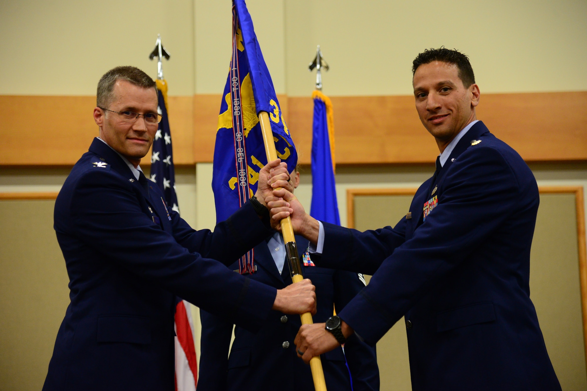 Maj. Frank Schiavone, right, accepts command of the 341st Contracting Squadron from Col. Marcus Glenn, 341st Mission Support Group commander, during an assumption of command ceremony July 26, 2018, at the Grizzly Bend at Malmstrom AFB, Mont.