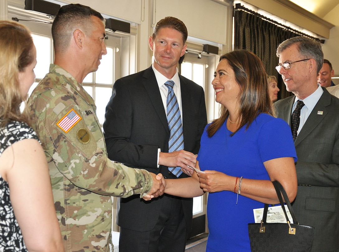 Col. Aaron Barta, U.S. Army Corps of Engineers Los Angeles District commander, center left, is greeted by Barbara Romero, deputy mayor of city services for Los Angeles, center right, as (from left to right) Melissa Barta, Col. Aaron Barta’s wife; David Van Dorpe, District deputy for programs and project management, Los Angeles District; and Gary Lee Moore, Los Angeles city engineer, look on.