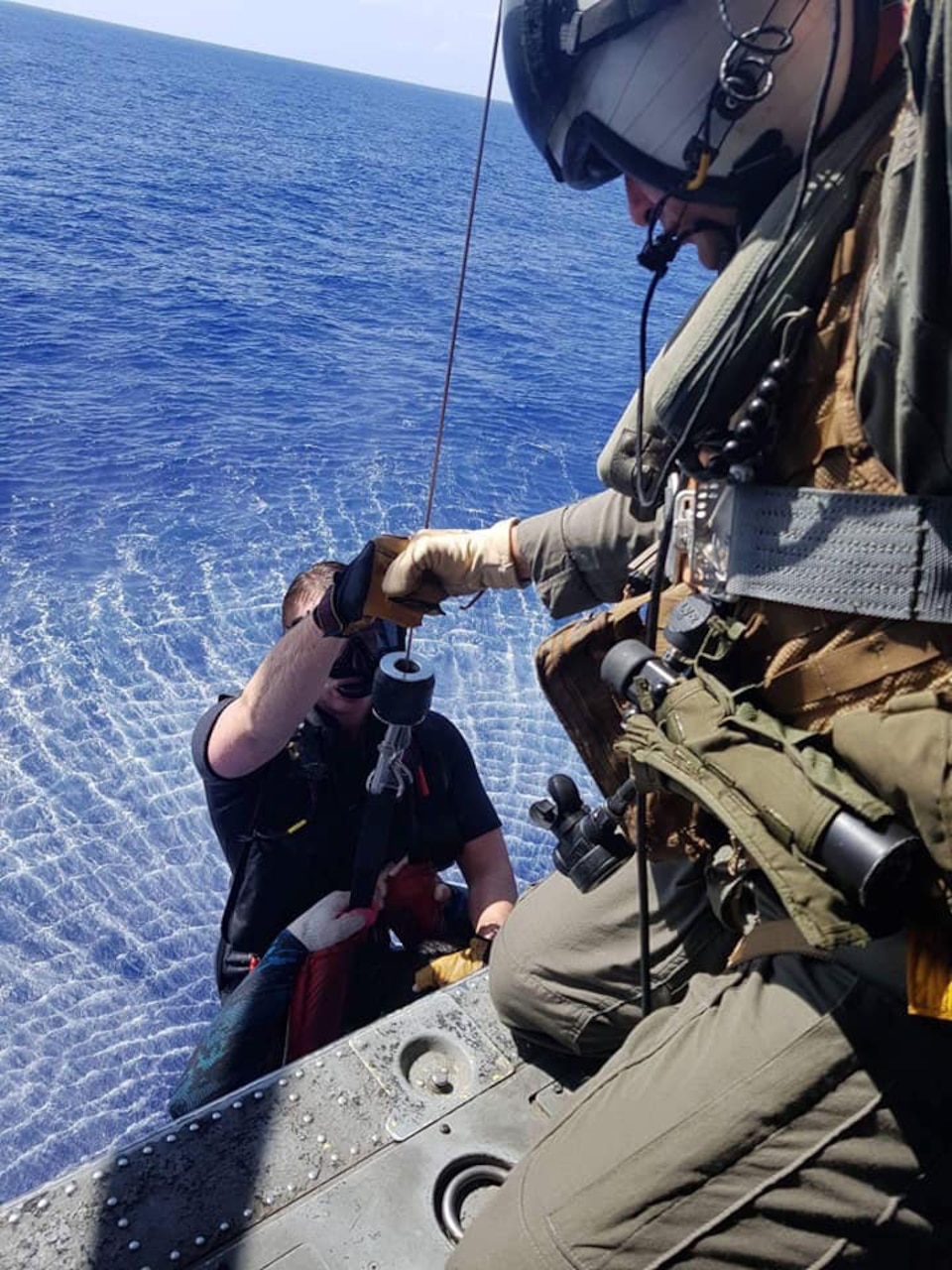 PACIFIC OCEAN (July 26, 2018) -- Sailors assigned to the Guam-based “Island Knights” from Helicopter Sea Combat Squadron (HSC) 25 rescue divers separated from their boat more than 15 miles from the Guam shore.