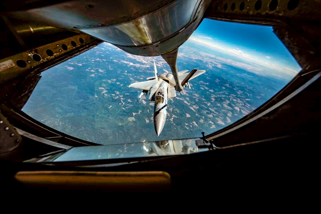 A jet approaches the boom of another jet.