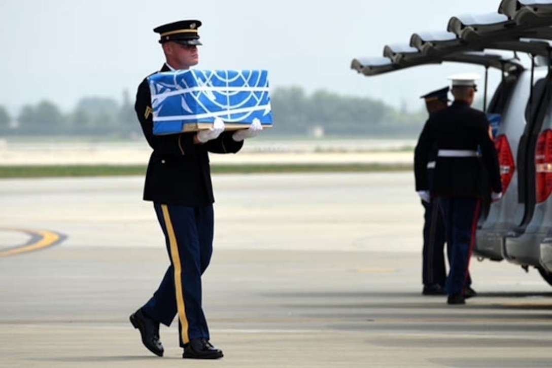 A United Nations Honor Guard member carries remains during a dignified return ceremony at Osan Air Base, South Korea.