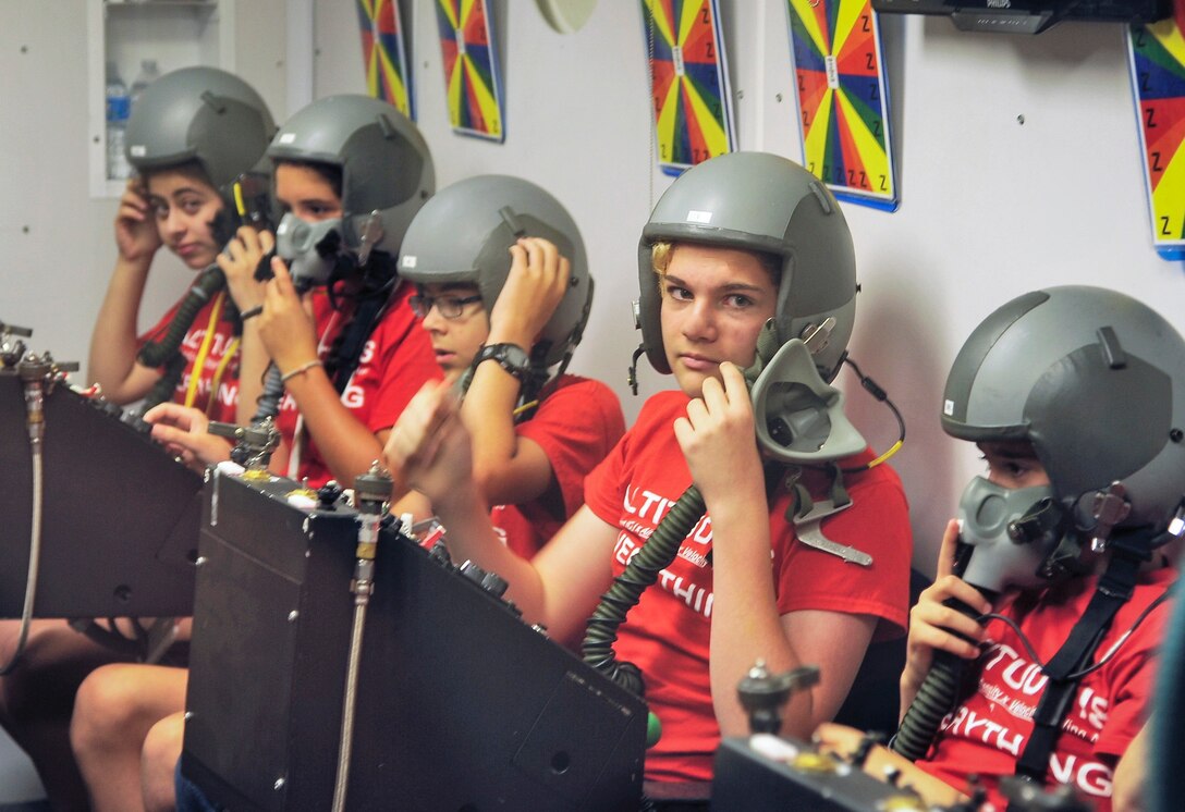 Air Camp participants don flight helmets and learn the effects of altitude in a simulation chamber at Wright-Patterson Air Force, Ohio. July 10, 2018.