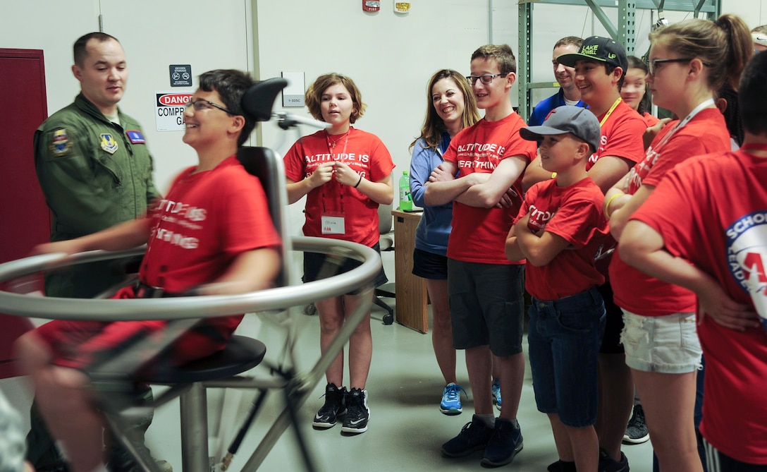 Air Camp participants learn about the effects of constant movement on pilots by taking turns in the Barnui spinning chair at Wright-Patterson Air Force, Ohio. July 10, 2018.