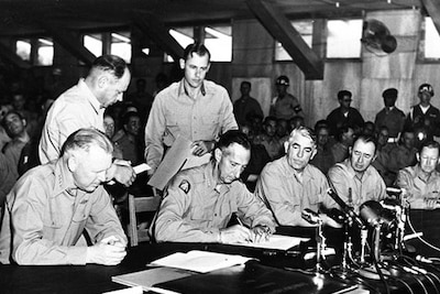 Army Gen. Mark W. Clark signs the Korean War Armistice agreement .