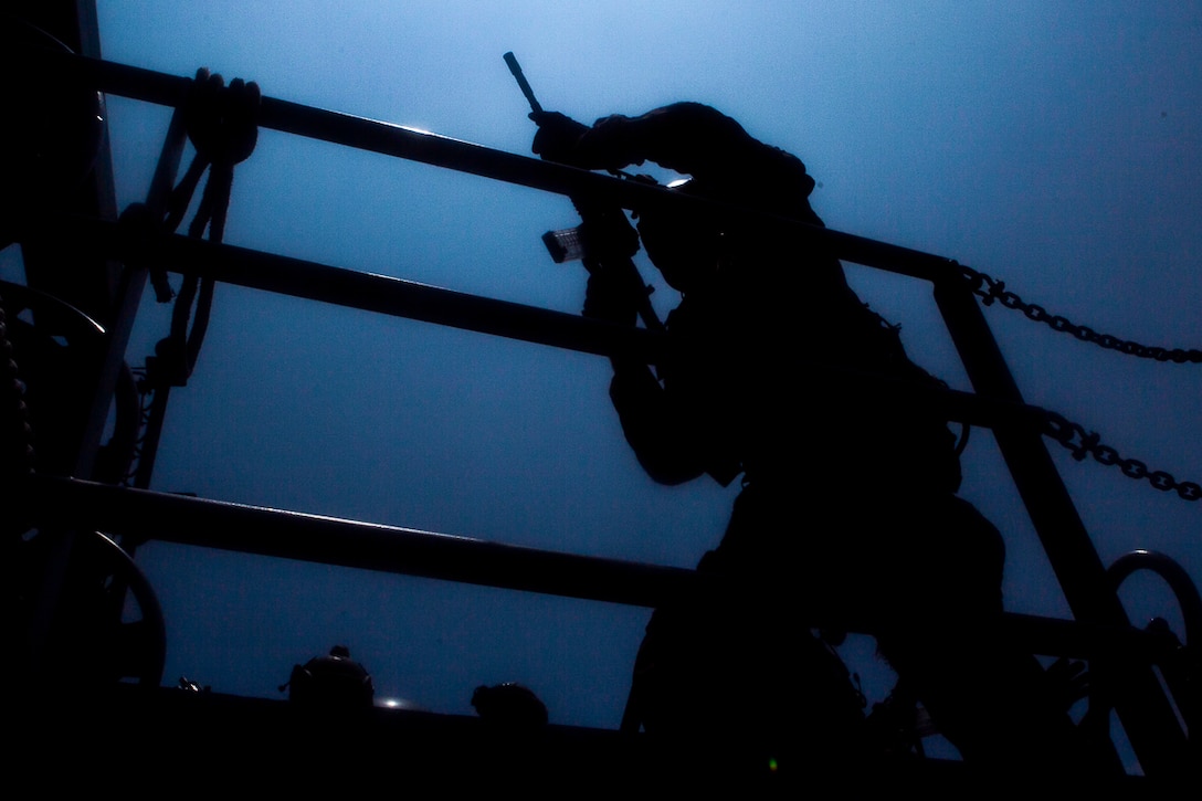 A reconnaissance Marine with the 31st Marine Expeditionary Unit's Force Reconnaissance Platoon searches for potential threats aboard a U.S. Army landing craft during a combined sea and airborne Visit, Board, Search and Seizure exercise as part of Realistic Urban Training Exercise, off the coast of Okinawa, Japan, July 26, 2017. Reconnaissance Marines with FPR boarded the landing craft from hovering aircraft while other teams raided the target vessel from small, inflatable rubber boats, known as Combat Rubber Raiding Craft. The 31st MEU, the Marine Corps’ only continuously forward-deployed MEU, provides a flexible force ready to perform a wide-range of military operations across the Indo-Pacific region. The 31st MEU, the Marine Corps’ only continuously forward-deployed MEU, provides a flexible force ready to perform a wide-range of military operations across the Indo-Pacific region.
