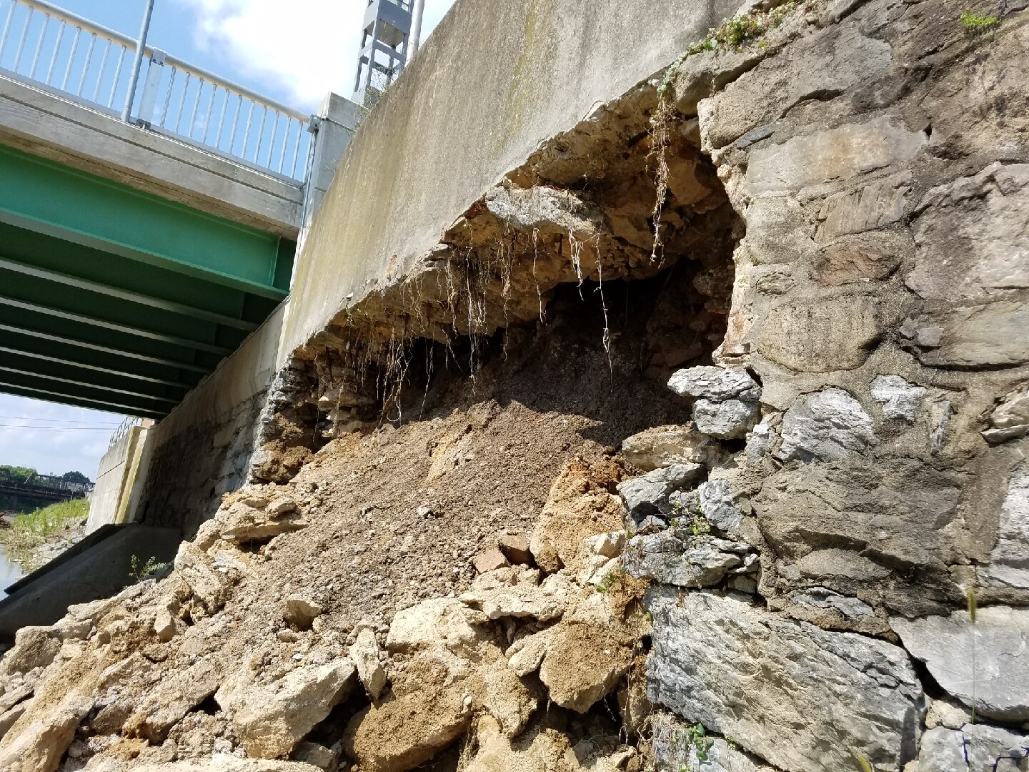 An approximately 20-foot-wide section of channel wall that collapsed into Codorus Creek immediately upstream of the Philadelphia Street Bridge in York, Pennsylvania, July 26, 2018. This wall is part of the Army Corps Codorus Creek flood risk management project, but its purpose is to keep water within the channel, not reduce flooding. It is not part of a levee or floodwall.
