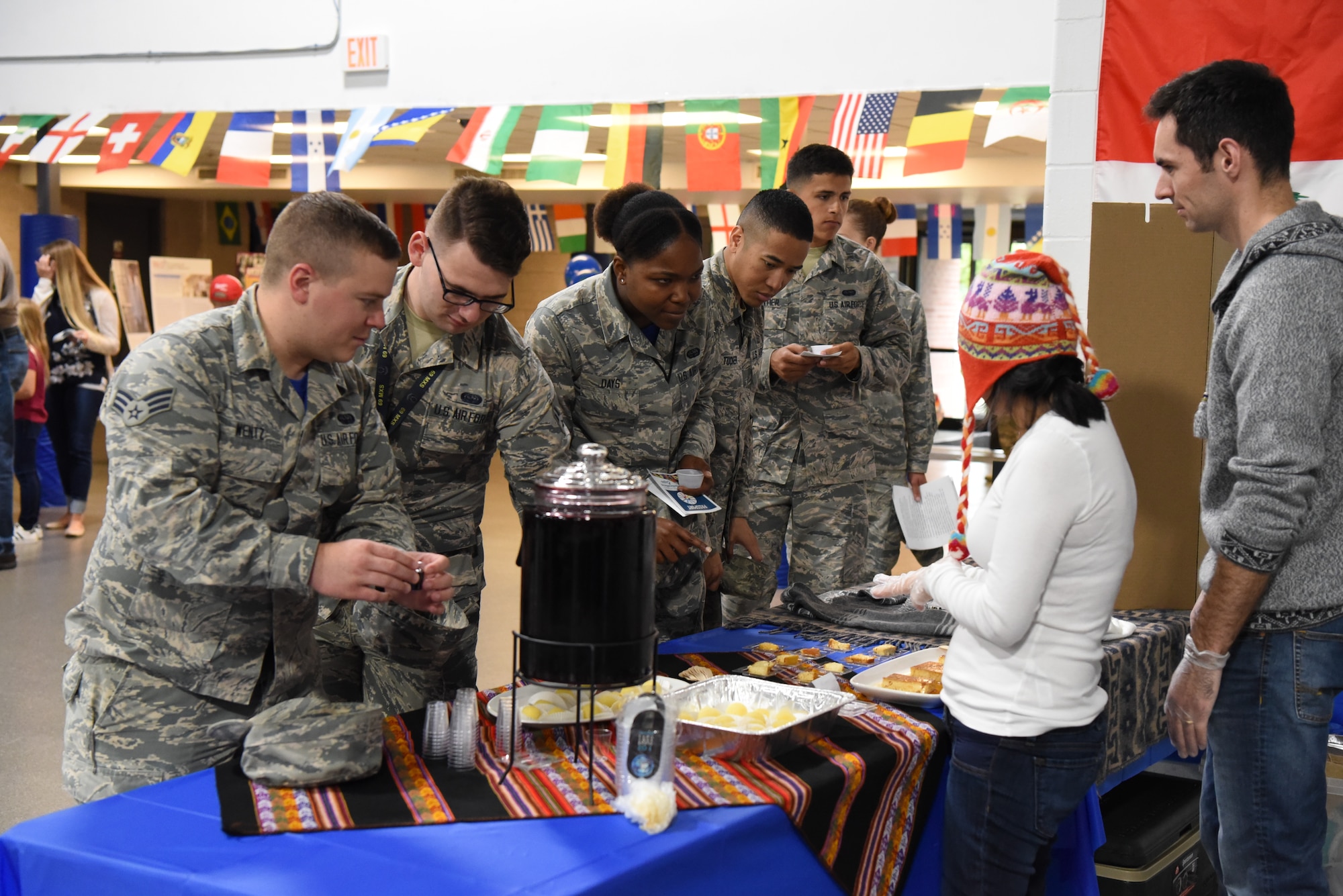 Airmen gather to sample food at the multicultural expo June 20, 2018, at Grand Forks Air Force Base, North Dakota. Each booth had a dish from their respective culture, so that base residents could try out different tastes from all over the world. (U.S. Air Force photo by Airman 1st Class Melody Wolff)