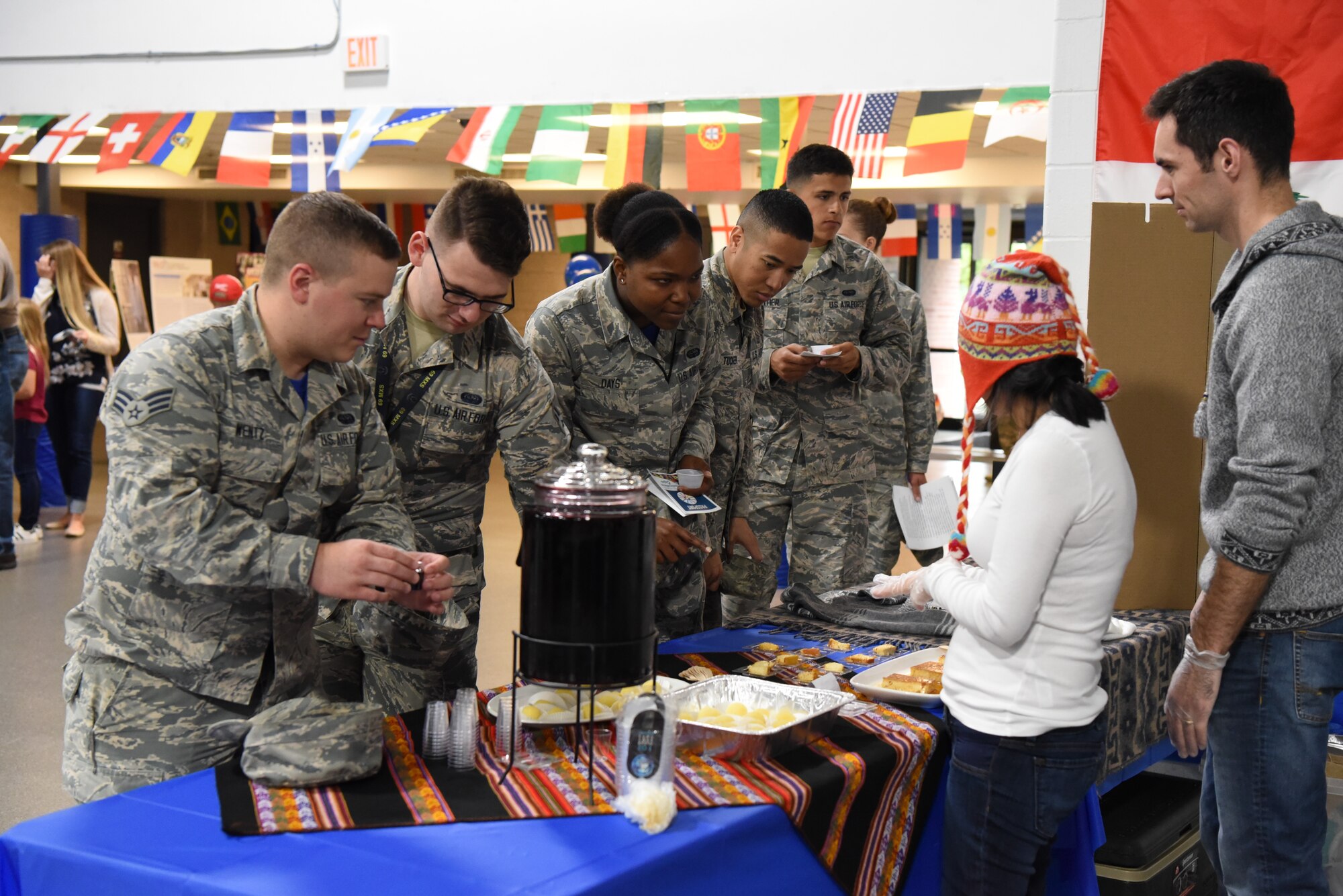 Airmen gather to sample food at the multicultural expo June 20, 2018, at Grand Forks Air Force Base, North Dakota. Each booth had a dish from their respective culture, so that base residents could try out different tastes from all over the world. (U.S. Air Force photo by Airman 1st Class Melody Wolff)
