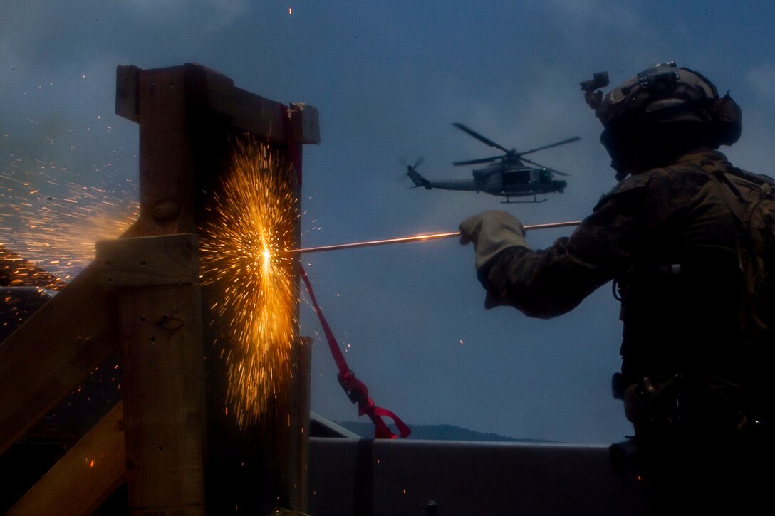 A reconnaissance Marine with the 31st Marine Expeditionary Unit's Force Reconnaissance Platoon uses an exothermic torch to cut through a steel obstacle during a combined sea and airborne Visit, Board, Search and Seizure exercise as part of Realistic Urban Training Exercise, off the coast of Okinawa, Japan, July 26, 2017. Reconnaissance Marines with FPR boarded the landing craft from hovering aircraft while other teams raided the target vessel from small, inflatable rubber boats, known as Combat Rubber Raiding Craft. The 31st MEU, the Marine Corps’ only continuously forward-deployed MEU, provides a flexible force ready to perform a wide-range of military operations across the Indo-Pacific region. The 31st MEU, the Marine Corps’ only continuously forward-deployed MEU, provides a flexible force ready to perform a wide-range of military operations across the Indo-Pacific region.