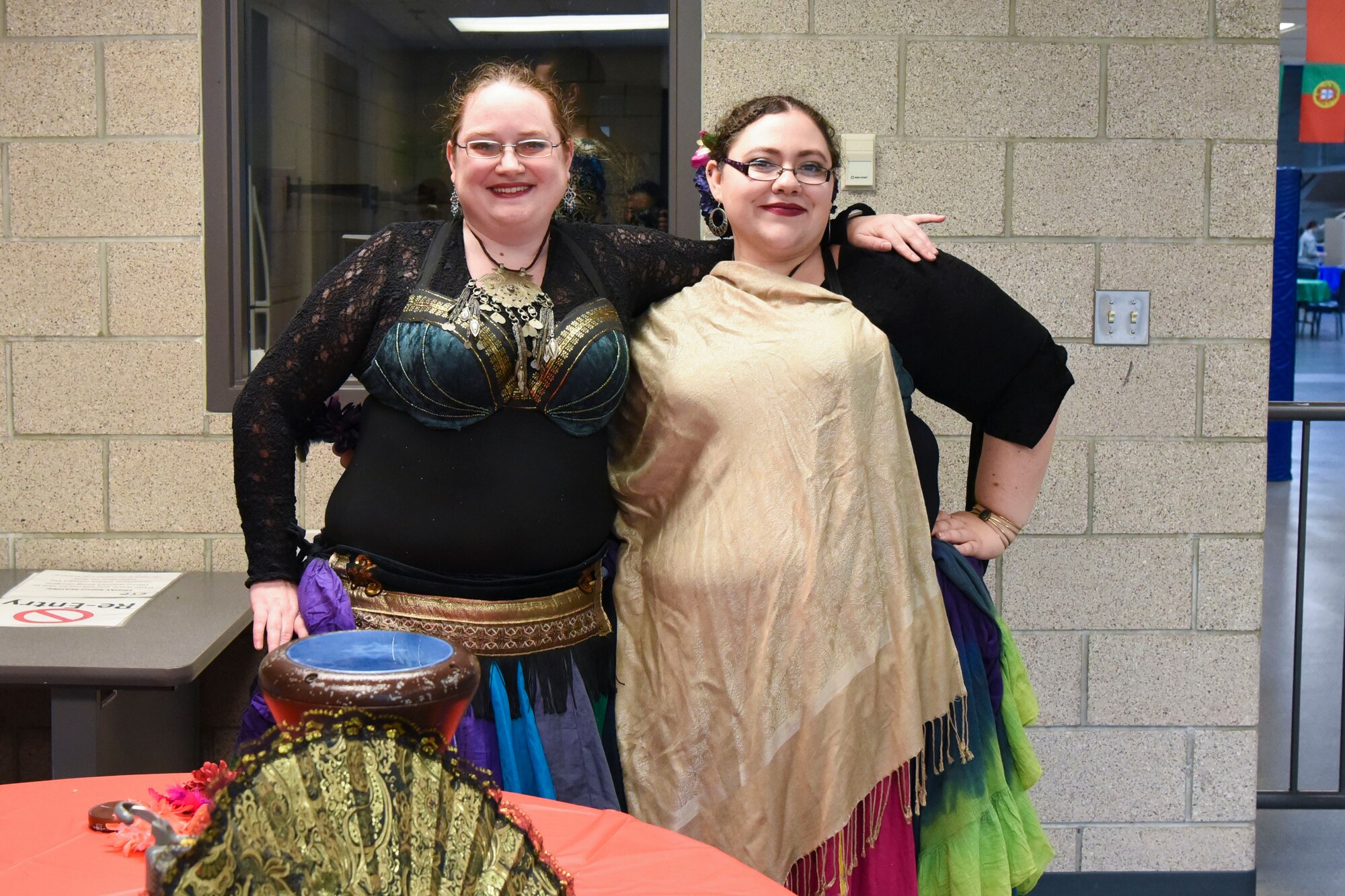 (Left) Kelly Ferguson and Amanda Burk, belly dancing instructors, pose for a photo June 20, 2018, at Grand Forks Air Force Base, North Dakota. Ferguson and Burk demonstrated the meditating benefits of belly dancing, and performed different techniques for those in attendance. (U.S. Air Force photo by Airman 1st Class Melody Wolff)