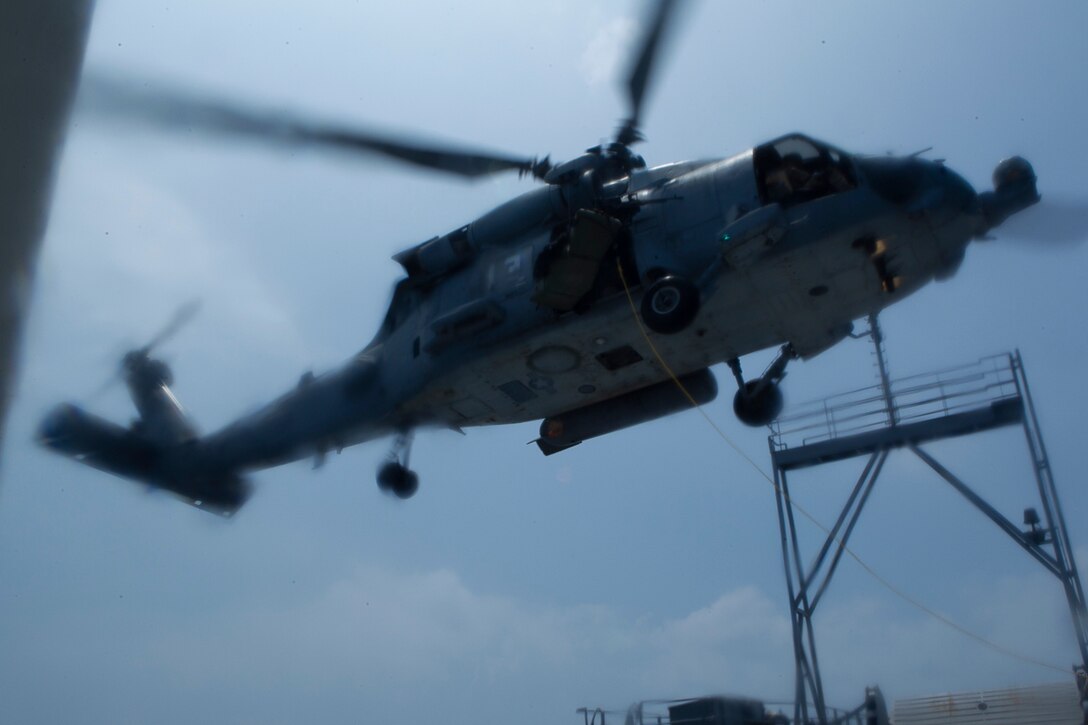 An MH-60 Seahawk helicopter hovers above a U.S. Army landing craft during a combined sea and airborne Visit, Board, Search and Seizure exercise as part of Realistic Urban Training Exercise, off the coast of Okinawa, Japan, July 26, 2017. Reconnaissance Marines with the 31st Marine Expeditionary Unit’s Force Reconnaissance Platoon boarded the landing craft from hovering aircraft while other teams raided the target vessel from small, inflatable rubber boats, known as Combat Rubber Raiding Craft. The 31st MEU, the Marine Corps’ only continuously forward-deployed MEU, provides a flexible force ready to perform a wide-range of military operations across the Indo-Pacific region. The 31st MEU, the Marine Corps’ only continuously forward-deployed MEU, provides a flexible force ready to perform a wide-range of military operations across the Indo-Pacific region.
