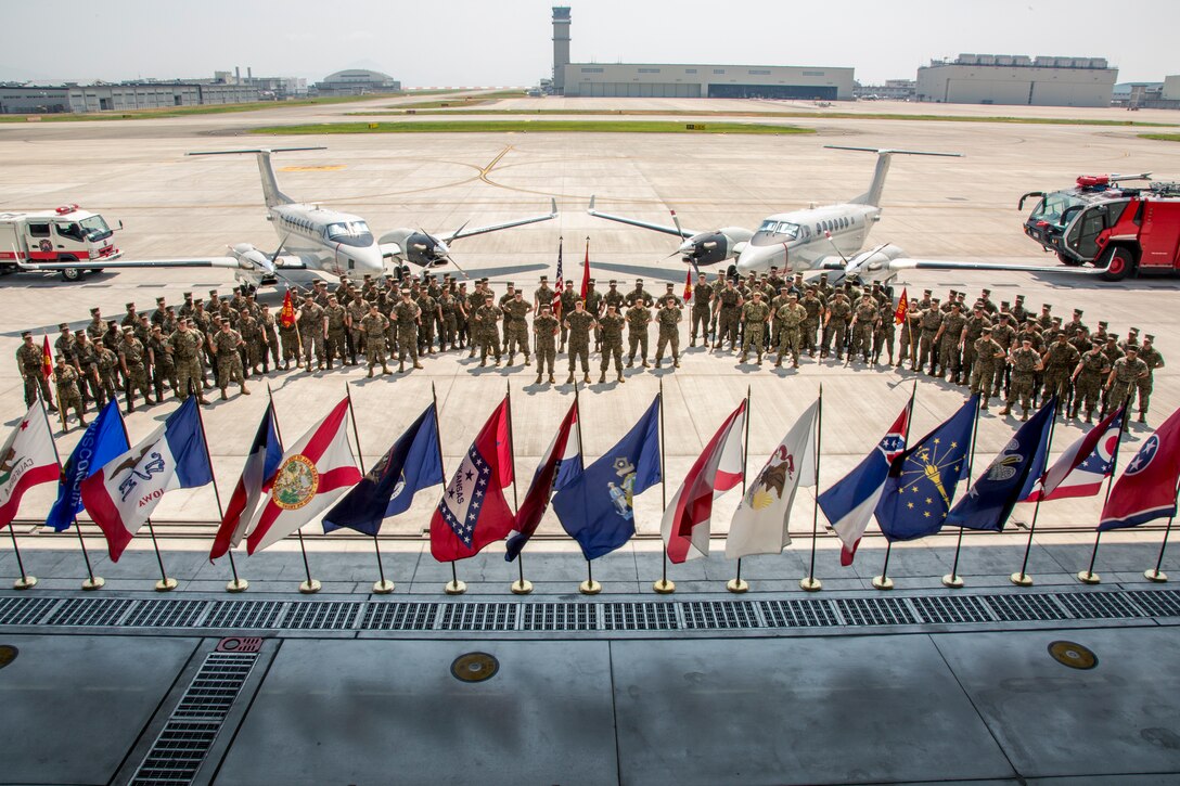 U.S. Marines with Headquarters and Headquarters Squadron gather together for a photo at Marine Corps Air Station Iwakuni, Japan, July 26, 2018. U.S. Marine Corps Lt. Col. Kevin Campbell, former commanding officer of Headquarters and Headquarters Squadron, relinquished his command to Lt. Col. Jason Kaufmann, commanding officer of H&HS during a change of command ceremony.