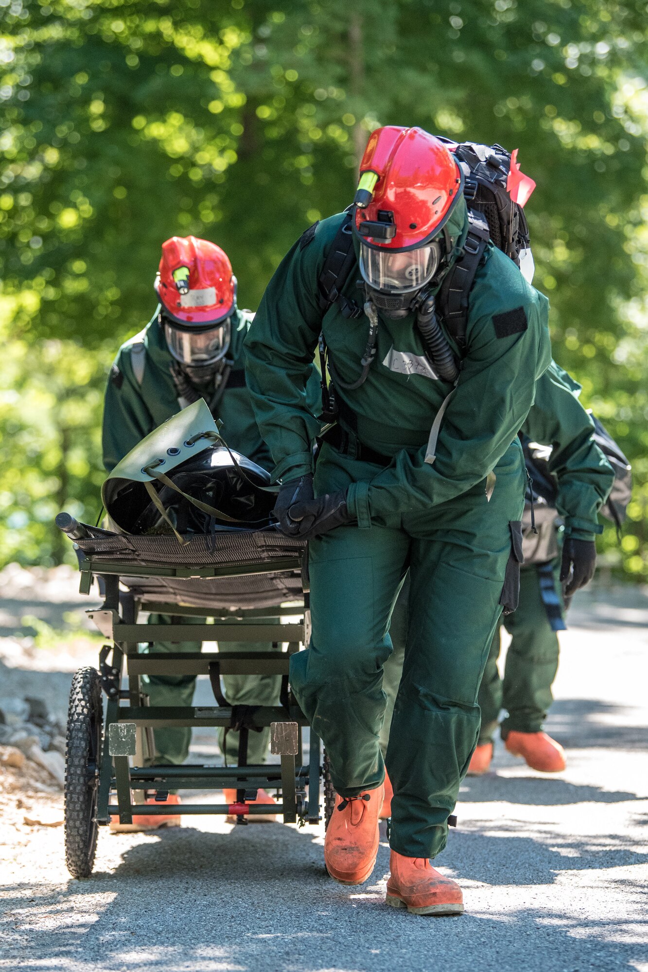 Airmen from the Kentucky Air National Guard’s Fatality Search and Recovery Team move a training mannequin with a gurney during a training exercise at Rough River State Resort Park in Falls of Rough, Ky., on July 18, 2018. Thirteen members of the 123rd Airlift Wing participated in the three-day exercise to simulate the recovery and repatriation of fallen service members. (U.S. Air National Guard photo by Master Sgt. Phil Speck)
