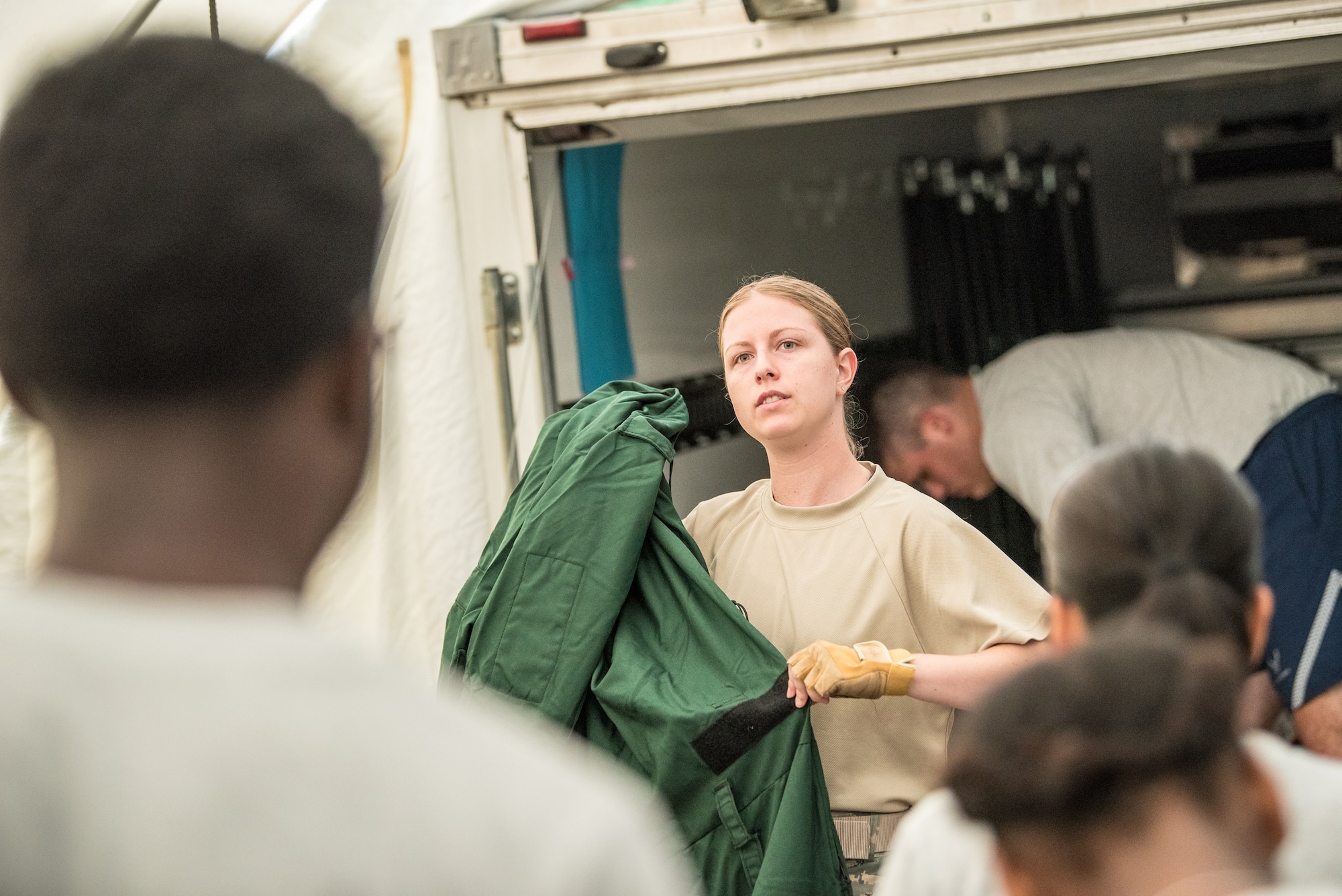 Senior Airman Sara Hozian, team lead with the Kentucky Air National Guard's Fatality Search and Recovery Team, leads a refresher course on the MT94 chemical, biological, radiological and nuclear defense suit prior to a training exercise at Rough River State Resort Park in Falls of Rough, Ky., on July 18, 2018. Thirteen members of the 123rd Airlift Wing participated in the three-day exercise to simulate the recovery and repatriation of fallen service members. (U.S. Air National Guard photo by Master Sgt. Phil Speck)