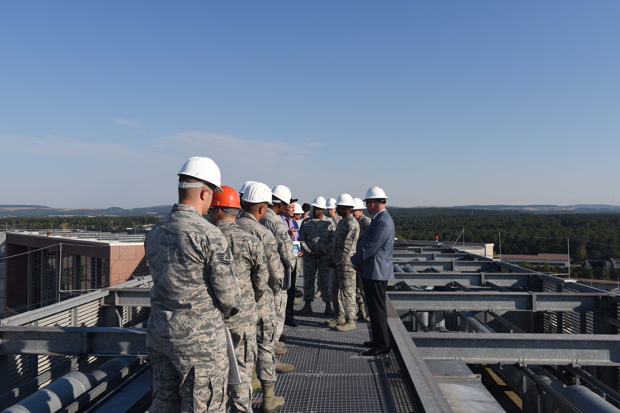 Chief Master Sgt. of the Air Force Kaleth O. Wright, Mr. Scott C. Lockard, 86 Airlift Wing vice director, and several noncommissioned officers stand on the roof of the Ramstein Inn June 26, 2018, on Ramstein Air Base, Germany. Ramstein leadership brought Wright to the roof to give him an elevated perspective of the base.