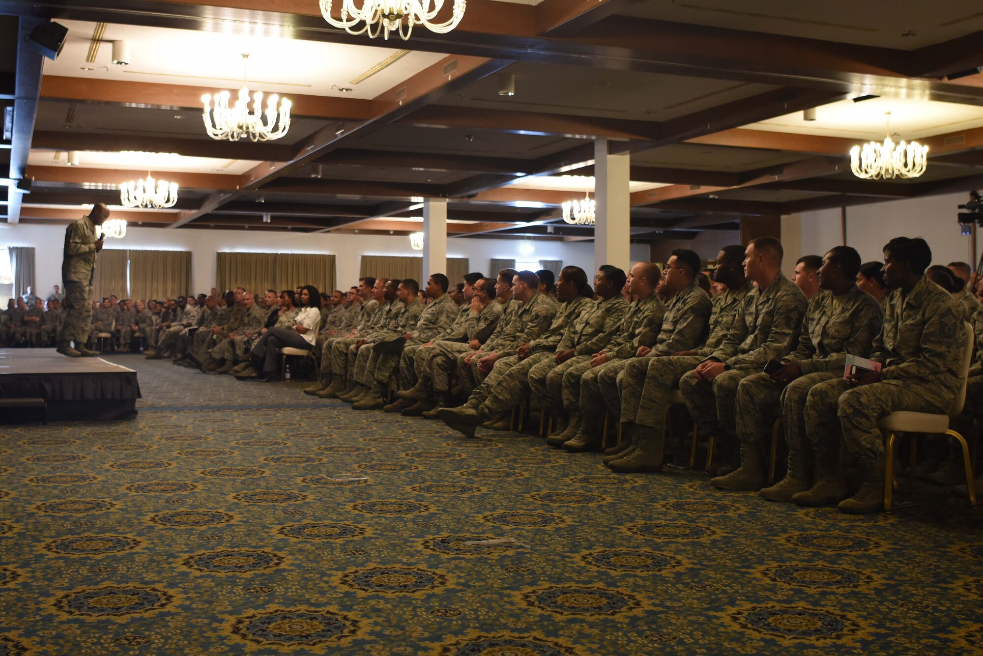 U.S. Airmen listen attentively to Chief Master Sgt. of the Air Force Kaleth O. Wright as he speaks at an enlisted all-call June 26, 2018 on Ramstein Air Base, Germany. More than 1,300 U.S. Air Force Airmen packed in the Ramstein Officers’ Club to hear Wright speak.