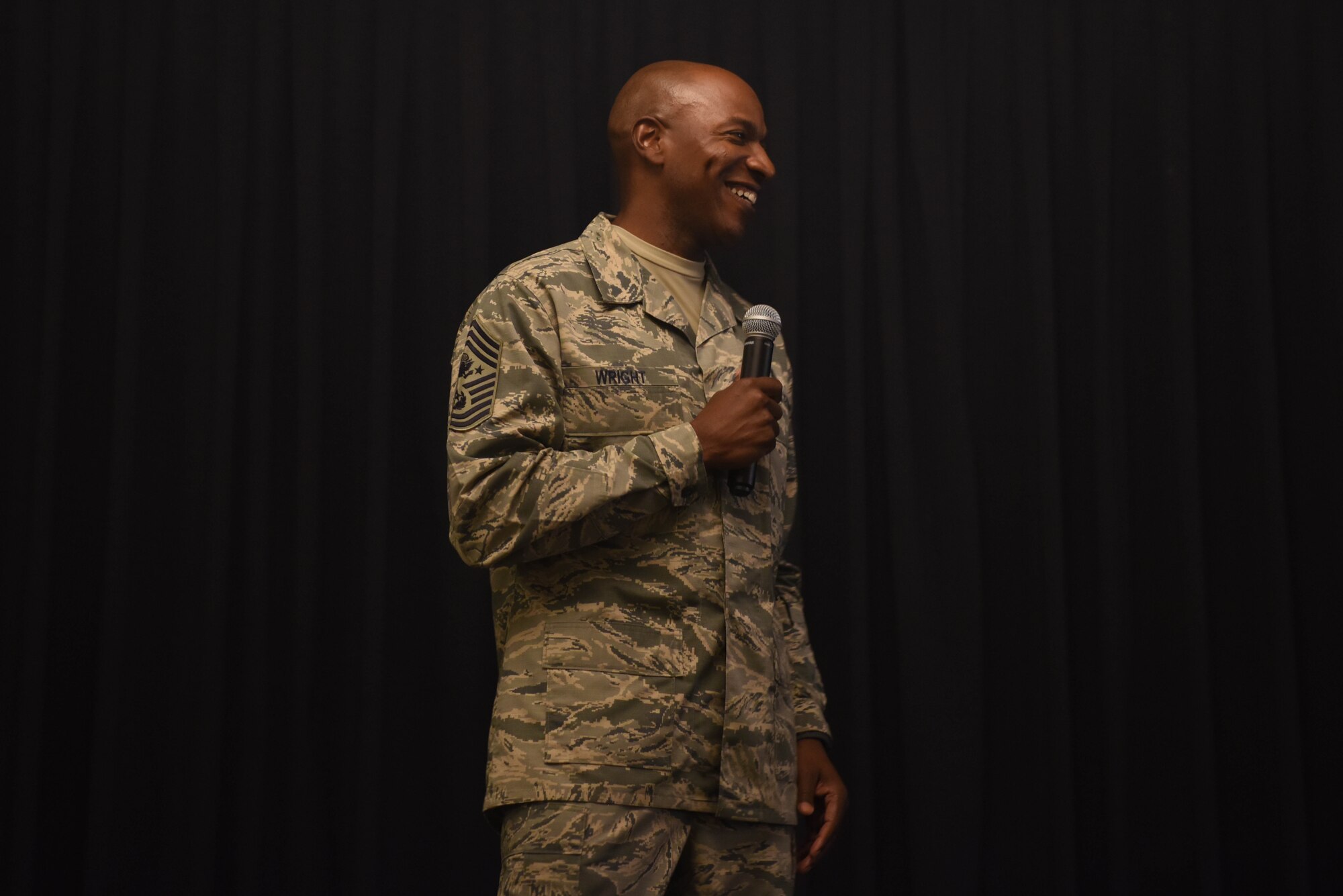 Chief Master Sgt. of the Air Force Kaleth O. Wright smiles as he addresses questions from Airmen in the audience at an enlisted all-call June 26, 2018 on Ramstein Air Base, Germany. Wright spoke about the importance of continued innovation in the Air Force and the significance of resiliency.