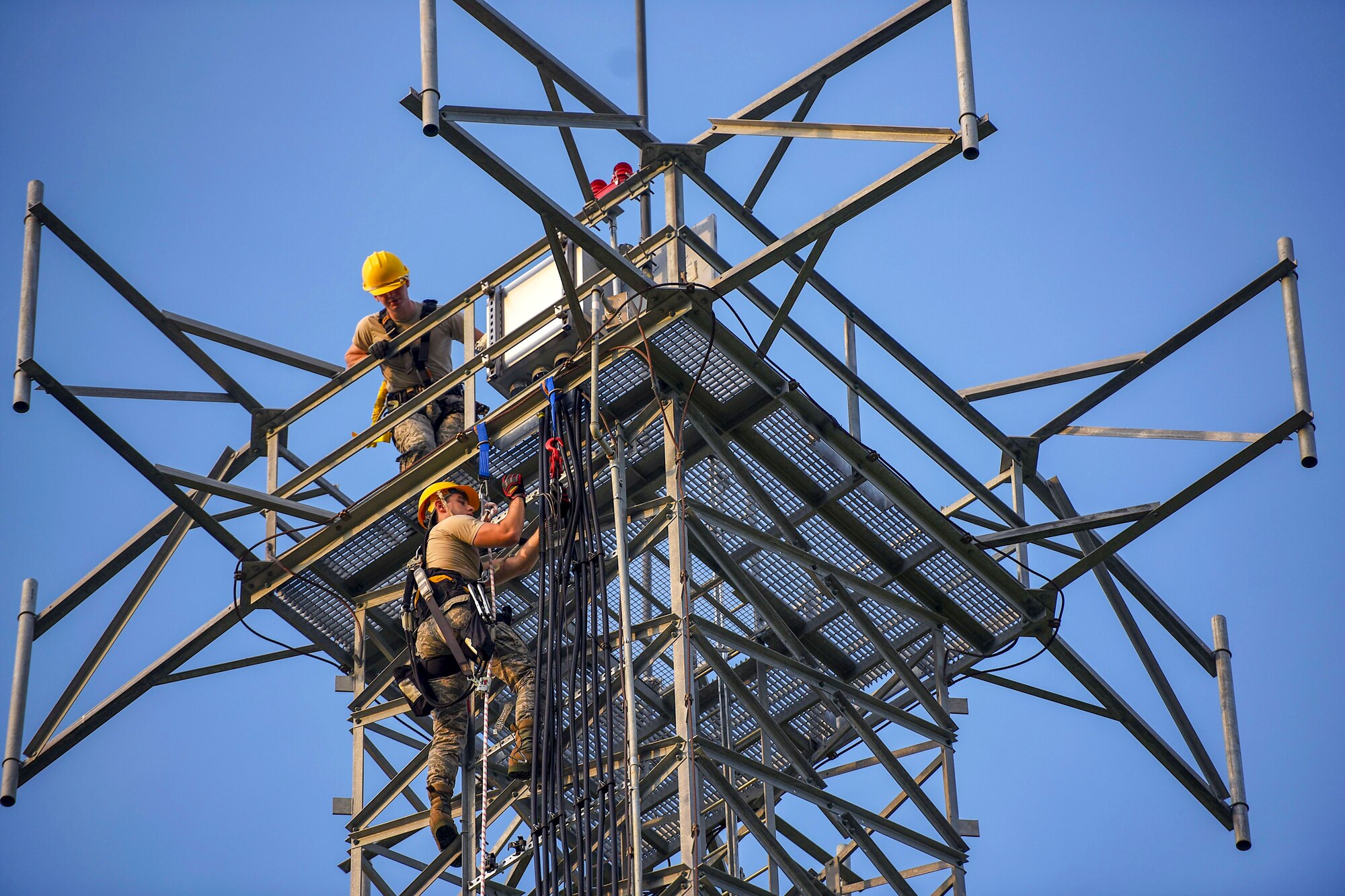 Airman Jacob Pugh and Airman 1st Class Brandon Culp, 14th Operations Support Squadron Radar, Airfield and Weather Systems journeymen, attach new wiring on a radio tower July 16, 2018, on Columbus Air Force Base, Miss. The RAWS unit supports base and regional radar equipment, ground-to-air radios and weather systems that support air traffic control, the National Weather Service, and command and control across the wing. (U.S. Air Force photo by Airman 1st Class Keith Holcomb)