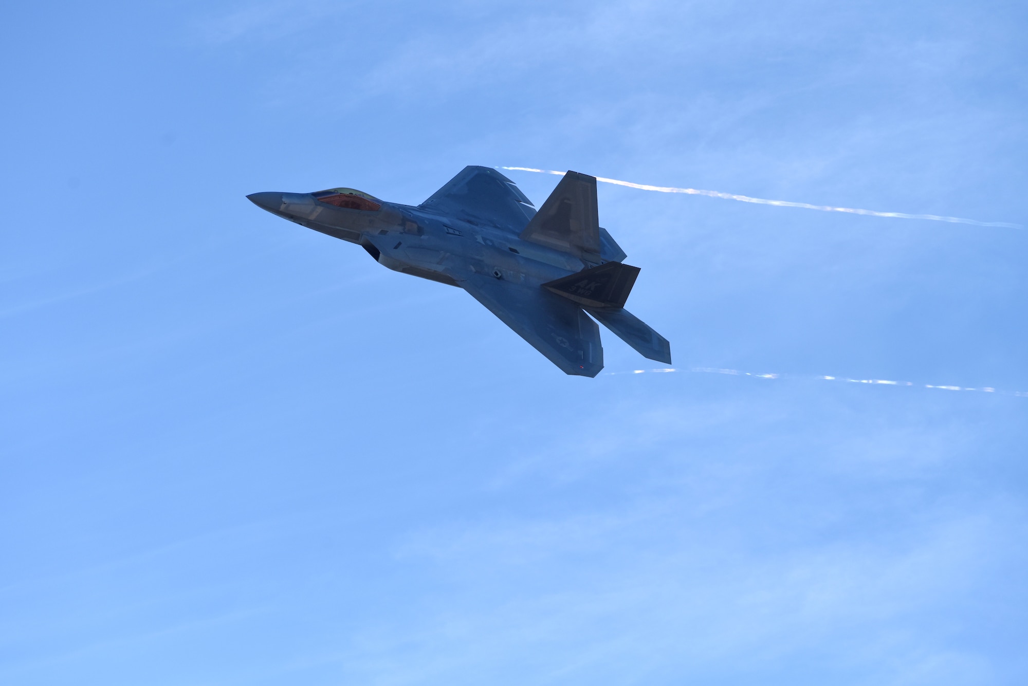 Col. Christopher J. Niemi, 3rd Wing commander, conducts his “fini flight” in an F-22 Raptor, July 19, 2018 at Joint Base Elmendorf-Richardson, Alaska. Lt. Gen. Kenneth S. Wilsbach, commander of Alaskan North American Aerospace Defense Command Region, Alaskan Command, U.S. Northern Command, and Eleventh Air Force, flew as Niemi’s wingman. (U.S. Air Force photo by Jamal Wilson)