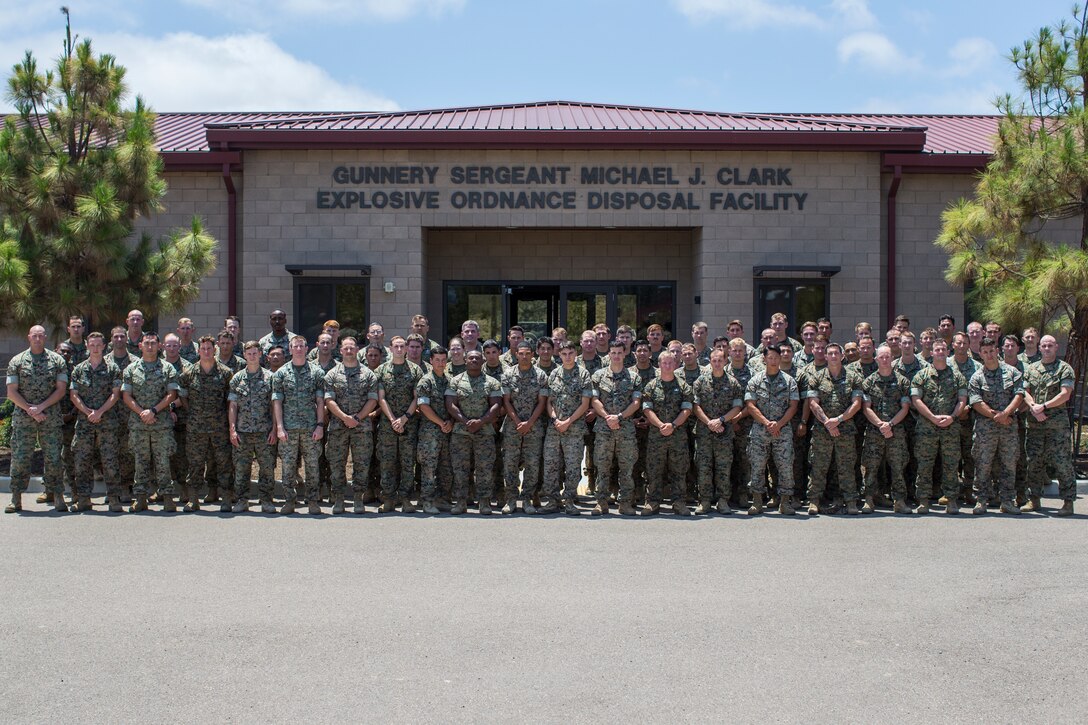 U.S. Marines with 1st Explosive Ordnance Disposal Company (EOD), 1st Marine Logistics Group, pose for a group photo following the 2nd annual Gunnery Sgt. Michael J. Clark Commemoration Ceremony at Marine Corps Base Camp Pendleton, California, July 20, 2018. The ceremony was conducted to build camaraderie within the unit while paying tribute to past EOD technicians who gave the ultimate sacrifice. (U.S. Marine Corps photo by Cpl. Dylan Chagnon)