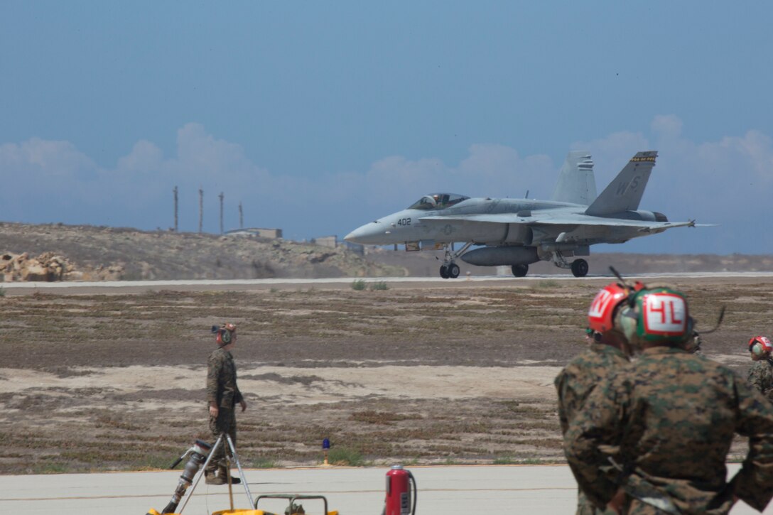 An F/A-18C with Marine Wing Support Squadron (MWSS) 373 arrives down the runway at a forward arming and refueling point during Exercise Summer Fury 2018, at San Clemente Island, Calif., July 23. Summer Fury is designed to increase the functionality and effectiveness of 3rd Marine Aircraft Wing while also enhancing Marine Air-Ground Task Force and naval integration with participating I Marine Expeditionary Force and naval units. (U.S. Marine photograph by Cpl. Jacob Pruitt /Released)