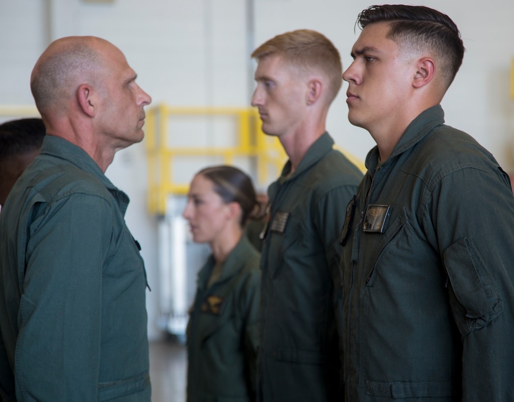 Capt. Ryan J. Boyer, Capt. Molly A. O’Malley, and Sgt. Garrett D. Mills of Marine Heavy Helicopter Squadron (HMH) 462, Marine Aircraft Group (MAG) 16, 3rd Marine Air Wing (MAW) receive the Air Medal at Marine Corps Air Station Miramar, Calif., July 24. Maj. Gen. Kevin M. IIams, 3rd MAW commanding general, presents the Marines the medal for their valiant and immediate efforts to ensure the safety of their passengers after their aircraft caught fire during refueling operations off the coast of Okinawa, Japan, on Oct. 11, 2017. (Marine Corps photo by Sgt. Dominic Romero/Released)