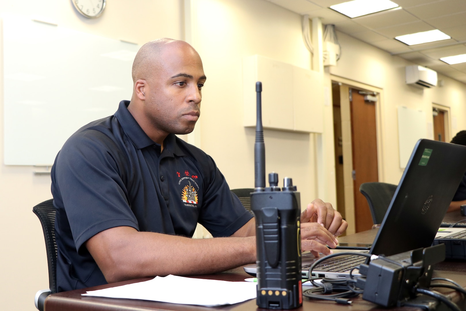 Army Staff Sgt. Rayshod Thompson, administrative noncommissioned officer, 33rd Civil Support Team, District of Columbia National Guard, mans a workstation on July 17, 2018, in the CST joint operations center in the D.C. Armory, in Washington, D.C. A part of Thompson’s responsibilities were to maintain real time information of all surveying members of the CST stationed throughout D.C. during the 2018 MLB All-Star Game. (U.S. Army National Guard photo by Kevin Valentine/released)