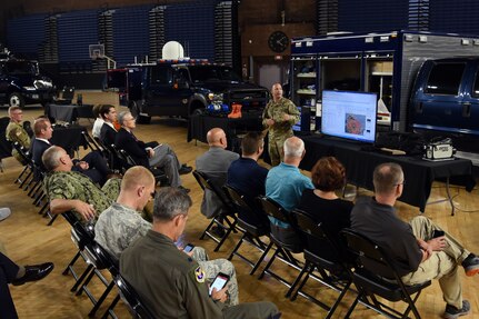Sgt. 1st Class Damien Silva, reconnaissance noncommissioned officer in charge, 33rd Civil Support Team, District of Columbia National Guard, briefs a National Guard and Air Force leadership on July 16, 2018, on the drill floor of the D.C. Armory in Washington, D.C. Silva briefed leadership on the capabilities that the 33rd and 31st CSTs were prepared to use if needed during the 2018 MLB All-Star Game at Nationals Park. (U.S. Army National Guard photo by Kevin Valentine/released)