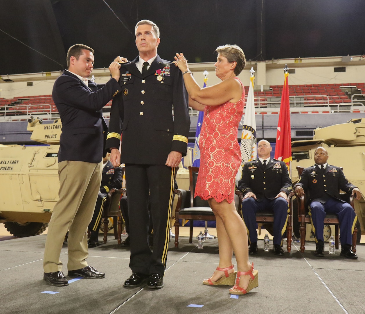 WASHINGTON- Members of Col. Robert K. Ryan's family pin on his new rank of brigadier general during a ceremony, June 10, 2018 at the District of Columbia Armory. Ryan is appointed Commander, Land Component Command, D.C. Army National Guard and will be responsible for strategic leadership and policies that affect all Army Soldiers in the D.C. National Guard, and for mission readiness of units assigned to the Land Component Command. (U.S. Army National Guard photo by Sgt. Adrian Shelton/Released)
