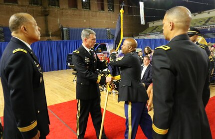 WASHINGTON - Brig. Gen. Robert K. Ryan passes the Land Component Command (LCC) flag to Command Sgt. Maj. Terrance A. Smith during the change of responsibility ceremony, June 10, 2018 at the District of Columbia Armory. Smith assumes responsibility as the new LCC command sergeant major, the top enlisted leader of Soldiers in units assigned to the LCC, and will ensure their readiness for all federal and district response missions in support of civil authorities. (U.S. Army National Guard photo by Sgt. Adrian Shelton/Released)
