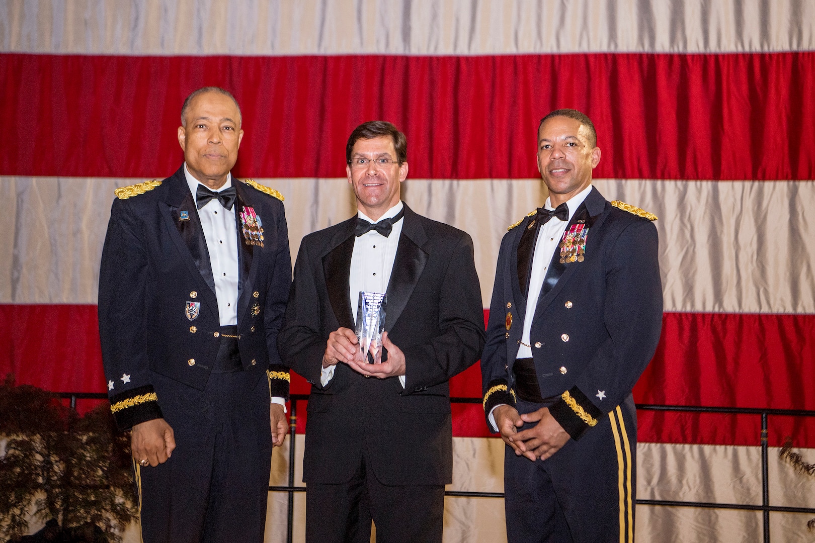Dr. Mark T. Esper, 23rd Secretary of the U.S. Army, assisted by Airman 1st Class Alejandro Irizarry-Cortes and Pfc. Monique Jones, cut the District of Columbia National Guard’s birthday cake, during the DCNG Military Ball at the DCNG Armory, May 5, 2018. The ball was held in the first week of May to commemorate the establishment of the DCNG on May 3, 1802. (U.S. Army photo by Daniel Torok)
