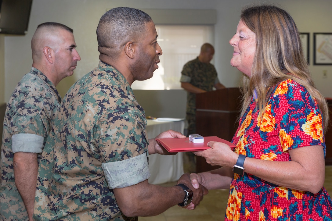 Nancy Johnson, Customer Support Specialist, is recognized for her 30 years of faithful service as a Civilian Marine during the quarterly awards breakfast aboard Marine Corps Logistics Base Barstow, Calif., July 17.