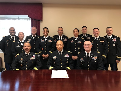 Brig. Gen. William J. Walker, acting commanding general, District of Columbia National Guard, accompanied by, Brig. Gen. Aaron R. Dean, II., adjutant general, D.C. National Guard, and Chief Warrant Officer 5 Michael R. Jewett, command chief warrant officer, D.C. National Guard, and members of the D.C. National Guard warrant officer cohort, signs a proclamation declaring 2018 the year of the warrant officer for the D.C. National Guard. 2018 marks the 100th anniversary of the U.S. Army Warrant Officer Corps. (U.S. Air National Guard photo by Maj. Byron Coward/released)