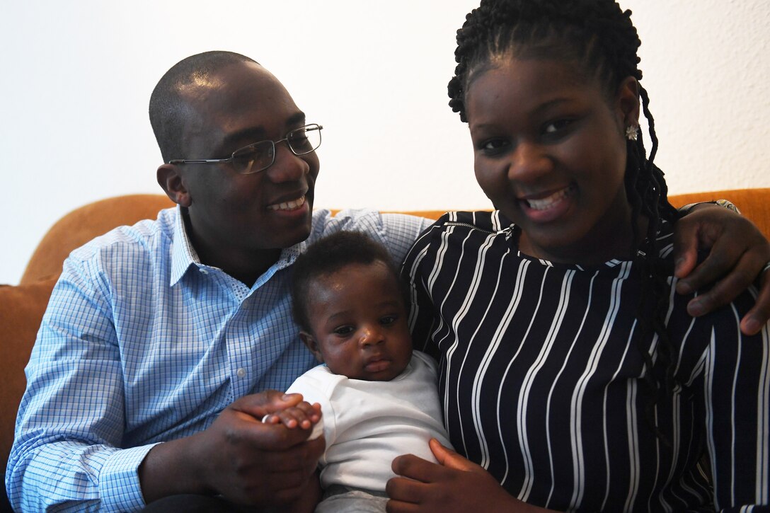 Air Force Senior Airman Pascal Nyowatchon, 435th Air Ground Operations Wing, sits with his wife and son in their home at Ramstein Air Base, Germany.