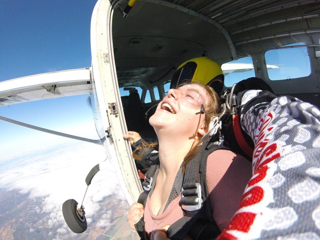 Airman 1st Class Aubree Milks, 30th Public Affairs photojournalist, is ready to jump from the plane, July 21, 2018 at Skydive Santa Barbara, Lompoc, Calif. Prepared to take her leap of faith, Milks awaits to take the plunge. (Complimentary photo)