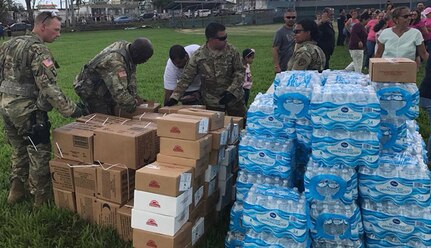 New York Army National Guard Soildiers assigned to the 442nd Military Police Company assist the New York Army National Guard's 3rd Battalion 142nd Aviation in delivering supplies in Bayamon and Orocovis, Puerto Rico on Oct. 11, 2017. Staff Sgt.  Mykel Christofferson, Staff Sgt Alberto Espinar,SPC Dewayne Alison and SPC Rebecca Batista and hand out some of the 4,320 Meals Ready to Eat and 9,216 water bottles iprovided.