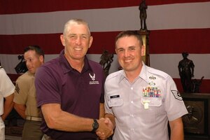 A fellow U.S. Air Force Shooting Team member congratulates Air Force Office of Special Investigations Special Agent David Ohlinger for earning the Air Force Distinguished Rifleman Badge at Camp Perry, Ohio, July 25, 2017. SA Ohlinger is the fifth member of his family to receive the highest individual award for excellence in marksmanship authorized by the U.S. Government open to all civilians and military branches. (Civilian Marksmanship Program photo)