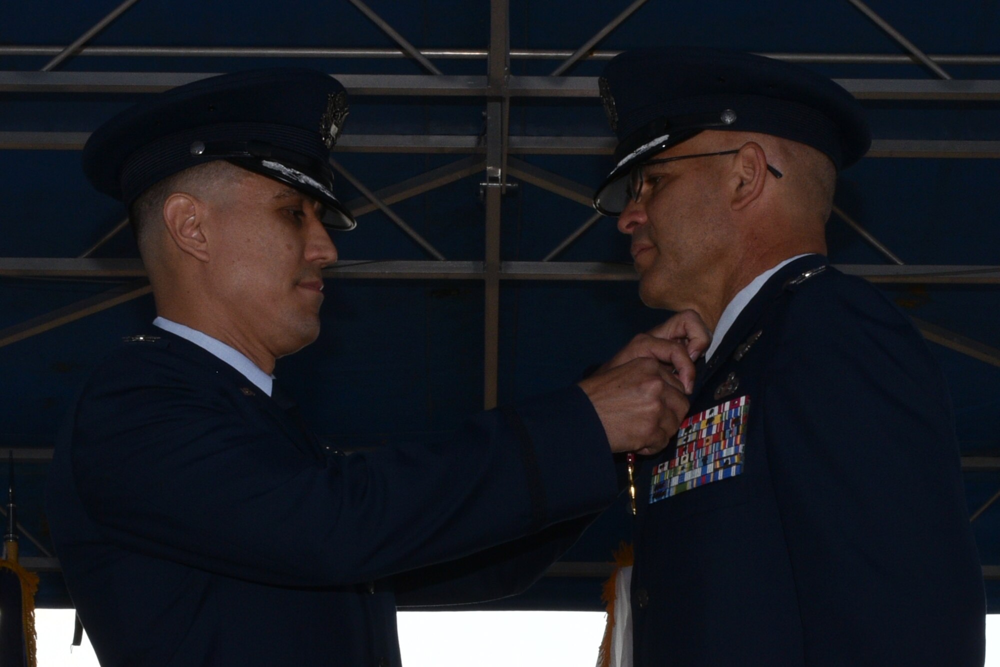U.S. Air Force Col. Ricky Mills, 17th Training Wing commander, pins a Legion of Merit medal to Col. Alex Ganster, 17th Training Group outgoing commander, during the 17th TRG Change of Command on the parade field on Goodfellow Air Force Base, Texas, July 27, 2018. The Legion of Merit is an award given for exceptionally meritorious conduct in the performance of outstanding services and achievements. (U.S. Air Force photo by Senior Airman Randall Moose/Released)