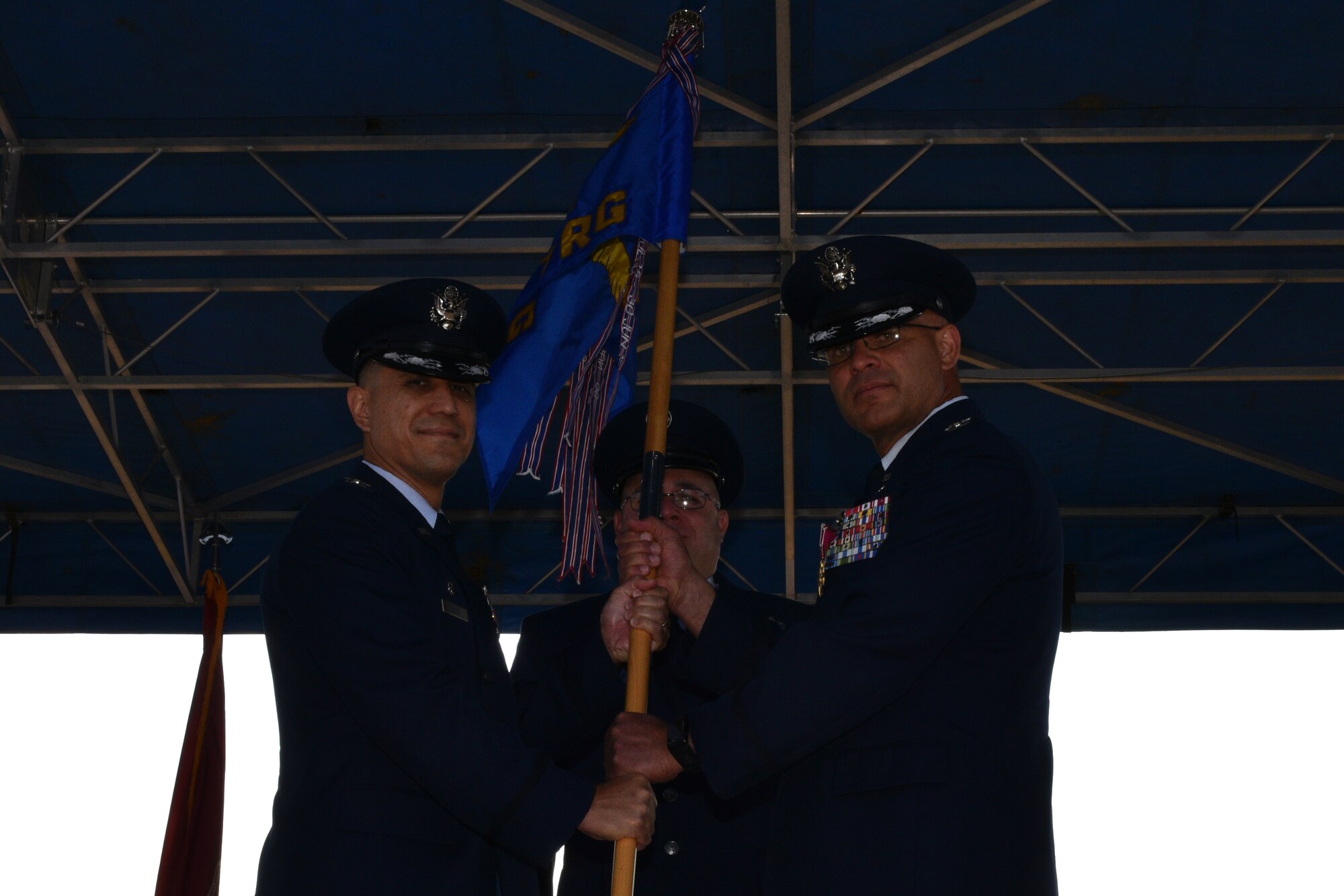 U.S. Air Force Col. Ricky Mills, 17th Training Wing commander, receives the 17th Training Group guideon from Col. Alex Ganster, 17th TRG outgoing commander, during the 17th TRG Change of Command on the parade field on Goodfellow Air Force Base, Texas, July 27, 2018. Ganster served as the 17th TRG commander from 2016 to 2018. (U.S. Air Force photo by Senior Airman Randall Moose/Released)