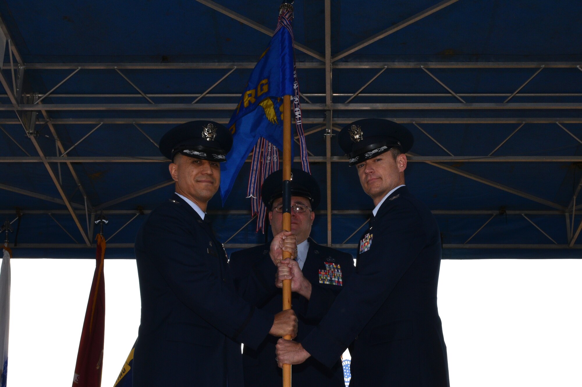 U.S. Air Force Col. Ricky Mills, 17th Training Wing commander, presents the 17th Training Group guideon to Col. Thomas Coakley, 17th TRG incoming commander, during the 17th TRG Change of Command on the parade field on Goodfellow Air Force Base, Texas, July 27, 2018. The passing of the guideon represents the formal exchange of command. (U.S. Air Force photo by Senior Airman Randall Moose/Released)