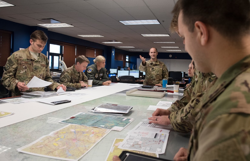 Capt. Tim Thackaberry, 16th Airlift Squadron pilot, goes over a mission plan July 19, 2018, prior to flying a sortie to test C-17 Pilot-Directed Airdrop capability.