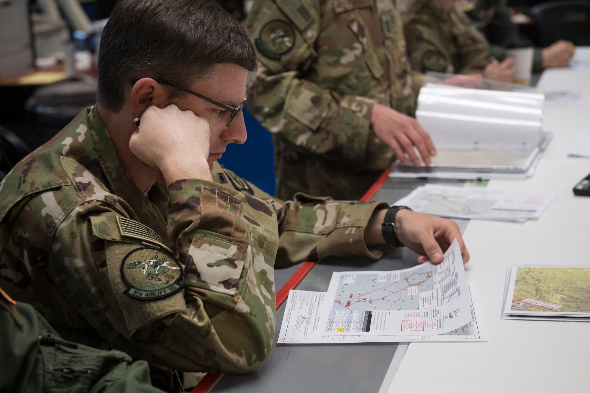 Capt. Nicholas Krause, 8th Airlift Squadron, Joint Base Lewis-McChord, Wash., goes over a map during a mission-planning meeting here July 19, 2018, in order to identify the visual cues used to perform a Pilot-Directed Airdrop.